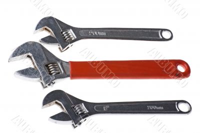 Three adjustable spanner on white