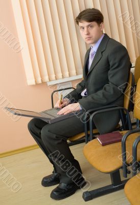 Person in a suit with the laptop Person in a suit with the laptop