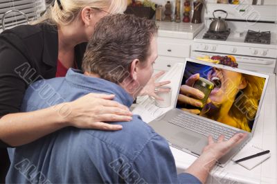 Couple In Kitchen Using Laptop - Music Entertainment