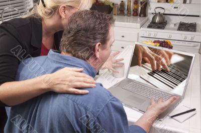 Couple In Kitchen Using Laptop - Music Performance