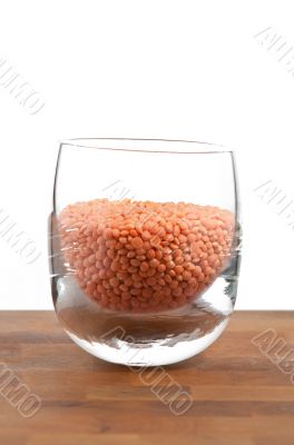 red lentils in glass on wooden table