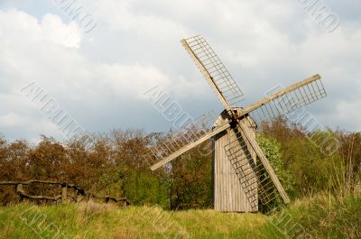 Old windmill and wooden fence