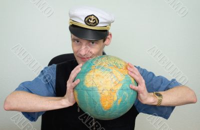 Guy in a sea uniform cap with globe