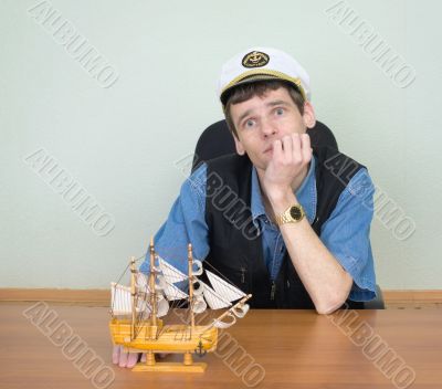 Man with model of a sailing vessel