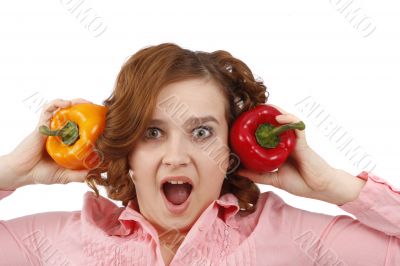 Woman is looking surprised with sweet peppers.