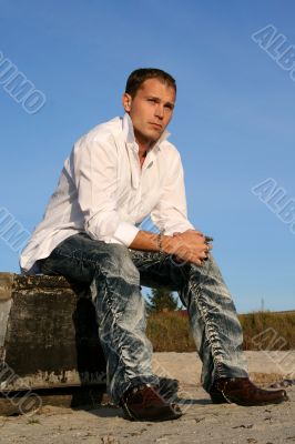 Man sitting by the turned boat