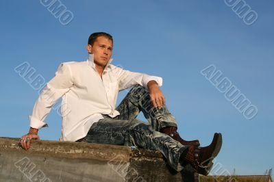 Man sitting by the turned boat