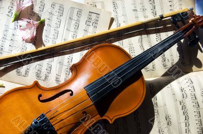 Old violin, fiddle-stick and music sheet