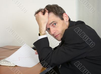 Sorrowful man at the office, on a workplace Sorrowful man at the office, on a workplace