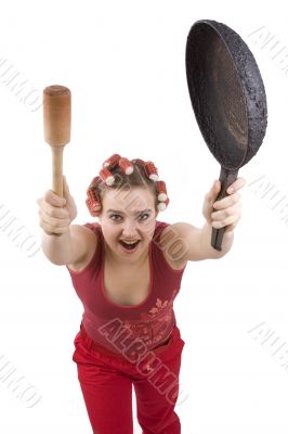 Housewife with curlers  holding a frying pan.