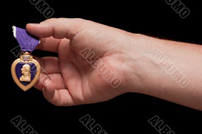 Man Holding Purple Heart War Medal