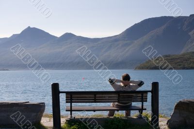 relaxed man on the bank of lake