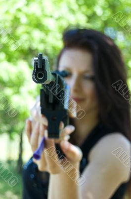 Woman aiming pneumatic gun