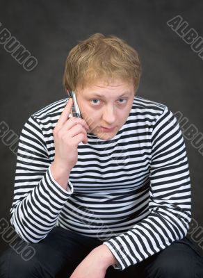 Seaman in a stripped vest with a mobile phone