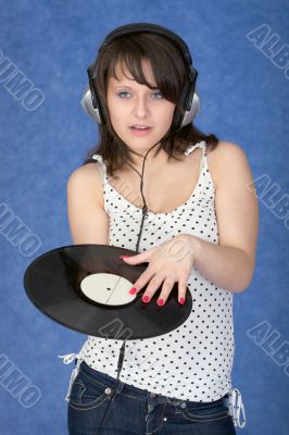 Girl in ear-phones with a phonograph record