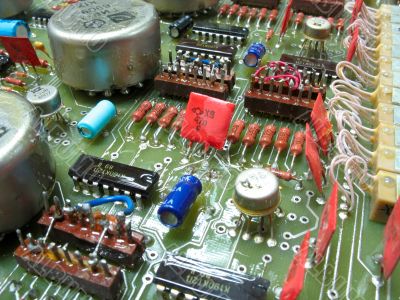 old circuit board from the 80th with colored electronic pieces