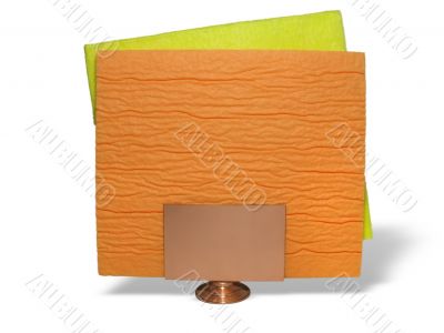 two yellow and orange napkins on a support over white background