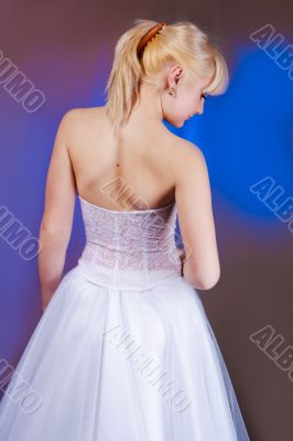 woman in wedding dress standing backwards