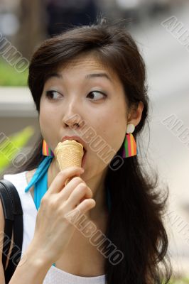 Portrait of a young Asian woman eating ice cream