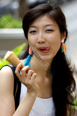 Portrait of a young Asian woman eating ice cream