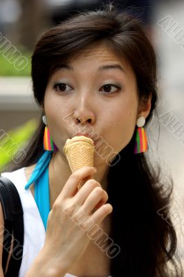 Portrait of a young Asian woman eating ice cream