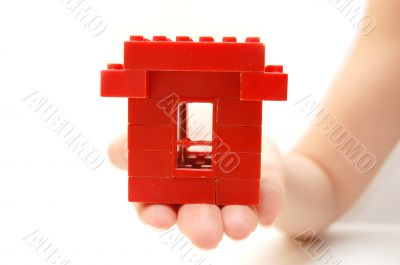 House symbol in a female hand House symbol in a female hand