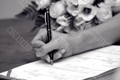 Woman`s hand near a wedding bouquet