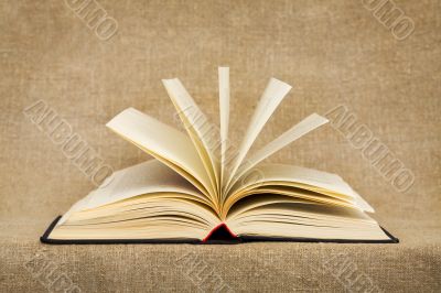 Disclosed book on the textile background Disclosed book on the textile background