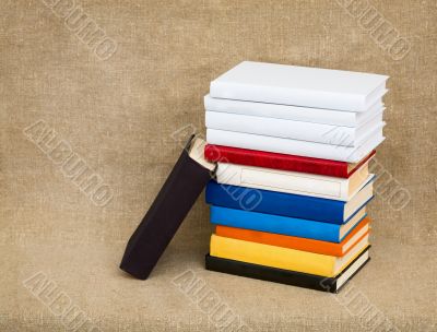Multicolor books on the fabric background Multicolor books on the fabric background