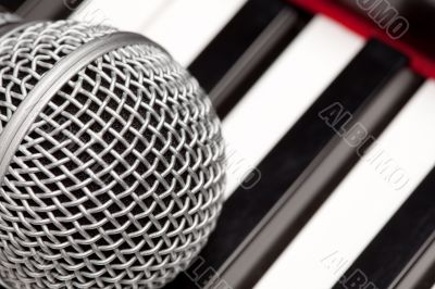 Microphone Laying on Electronic Keyboard