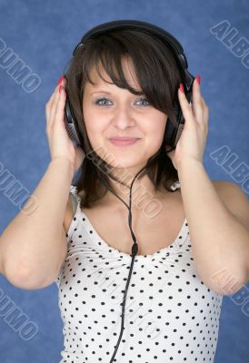 Girl in ear-phones on a blue background Girl in ear-phones on a blue background