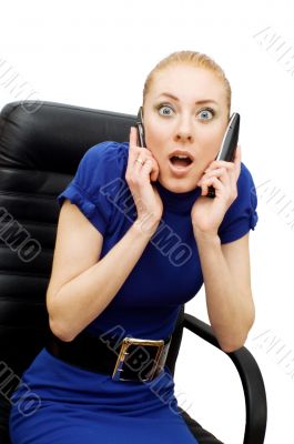 Busy and shocked businesswoman with two phones