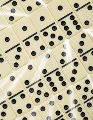 Background from dominoes with white rays Background from dominoes with white rays