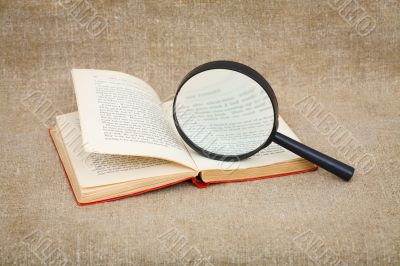 Still-life from a magnifier and book Still-life from a magnifier and book