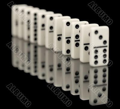 Some bones of dominoes put abreast on a black Some bones of dominoes put abreast on a black
