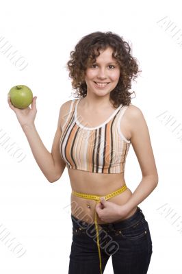 Smiling fit woman with measure tape and apple.