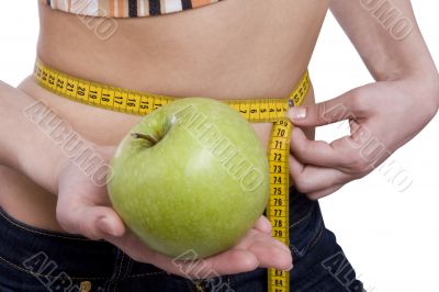 Waist is 65.5 centimeters.Woman measure tape apple