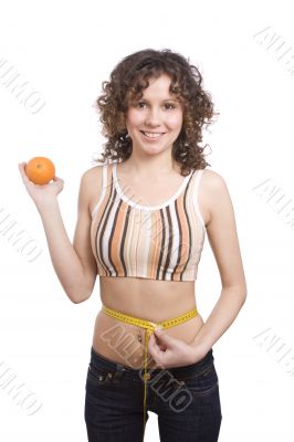 Smiling fit woman with measure tape and orange.