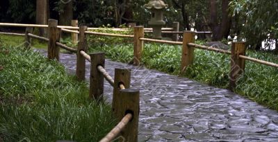 Stoned road with the wooden fence