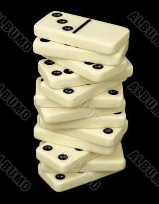 Tower from dominoes bones on a black