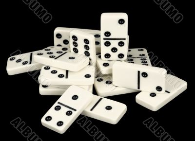 Heap of bones of dominoes on a black