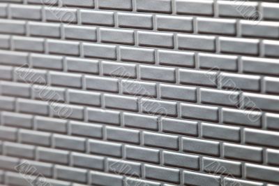 Wall of metallic bricks