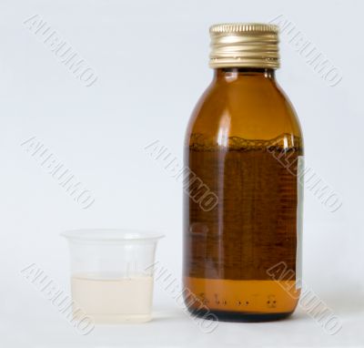 Bottle and beaker with medicine