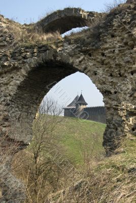 Two towers of ancient castle through arch