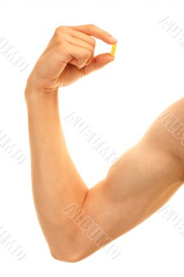 Man biceps hand holding steroids capsule