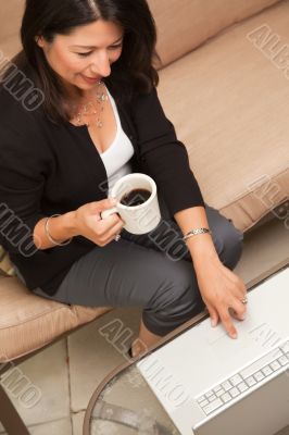 Hispanic Woman with Coffee and Laptop