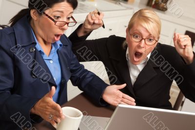 Businesswomen Celebrate Success on the Laptop