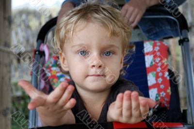 The thoughtful little girl in a carriage