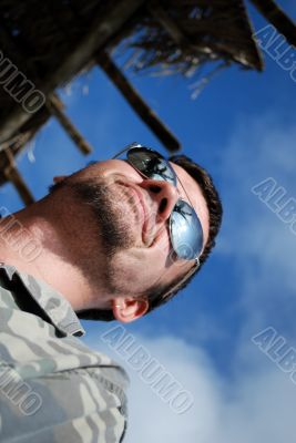 The happy young man in sun glasses