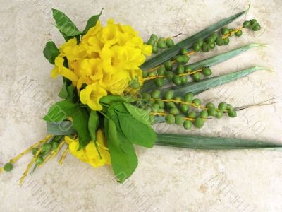 Bouquet from leaves of palm  and acacia on marble